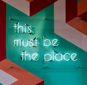 Neon sign saying this must be the place symbolizing reliable website development at Braske Agency