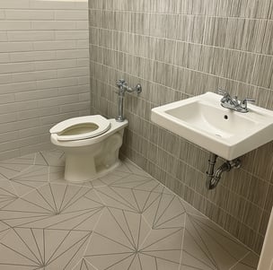 fully renovated bathroom with different tiles