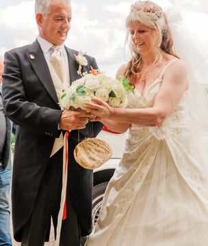 Couple With Their Bouquet Of Flowers