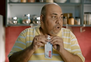 a man in a yellow shirt is holding a toothbrush, aditya satyajit, one for love, ad film, big basket