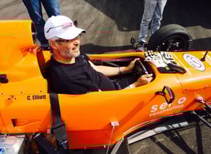 allan barss sitting in an open wheel style racecar 