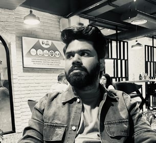 a man with a beard and a beard sitting at a table
