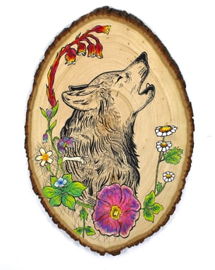 a drawing of a wolf and flowers on a wood slice