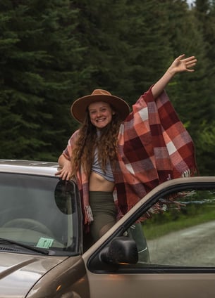 Banff photographer waving out a car window in Banff