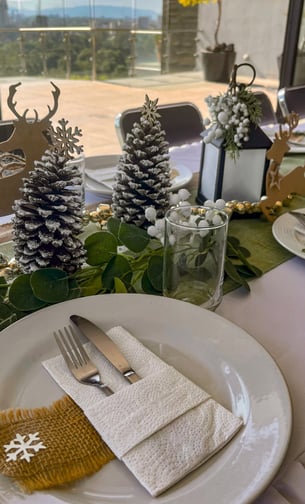 a table setting with pine cones and pine cones