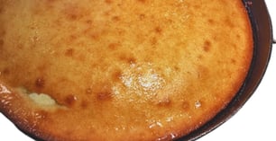 southern style cornbread soaked in butter in an black iron skillet