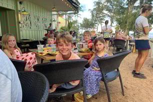 Kids dinning on a beachfront restuarant