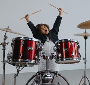 Child excited to play drums