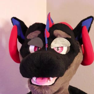 A dragon head made by Teto Creations featuring large curly horns, expressive moving eyelids and silicone teeth