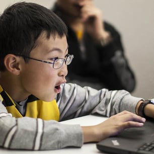 Young student excited about building and testing games in Roblox coding class