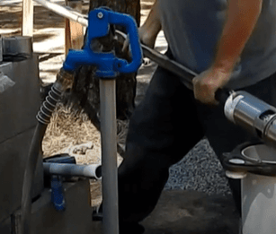 Technician about to snake the well pump into the well