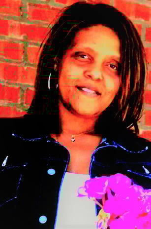 laurice a woman with a pink flower in her hand
