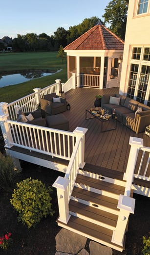 a deck with a couch and chairs and a table