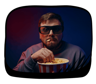 a man with a popcorn in his mouth and a bowl of popcorn