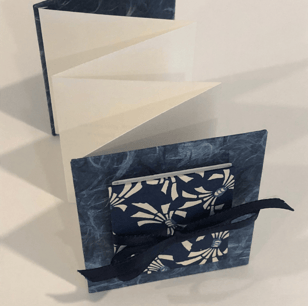 Accordion with Japanese paper and small accordion on cover, ribbon detail