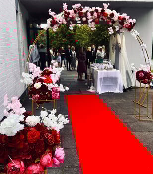 a red carpeted area with a red carpet and a red carpeted area with