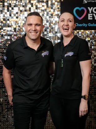 Carly and Kahn of SweetAz Co. at the silver shimmer wall for Layton Vision Foundation Gala.