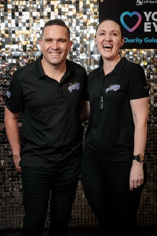 Carly and Kahn from Sweetaz Co. in front of the silver shimmer wall at the Layton Vision Foundation charity event in Brisbane