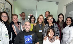 a group of people standing around a table