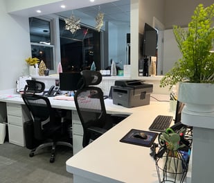 The desks to the receptionists inside a small office.