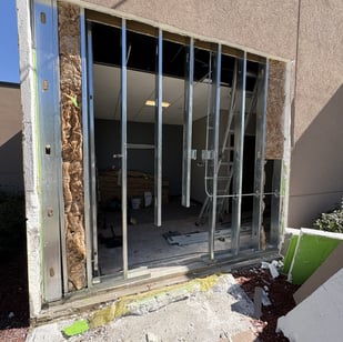 exposed studds and stucco after fixing damaged building frame