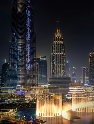 a cityscape of a city with a fountain in the foreground Dubai fountain burj khalifa