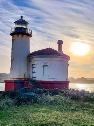 Oregon Coast - A lighthouse on a beach in Bandon