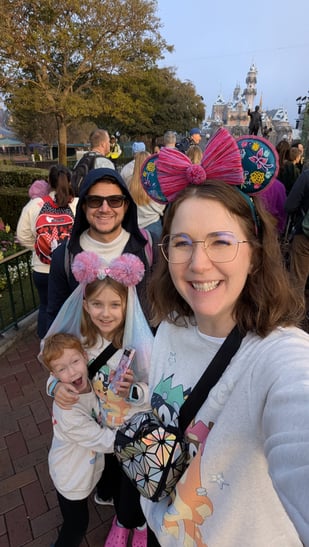 Katie and her family in front of Sleeping Beauty's Castle at Disneyland