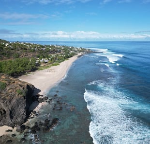 a beach with a sandy beach and a blue sky