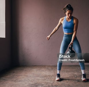 a woman holding a kettlebell