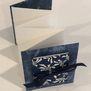 Accordion with Japanese paper and small accordion on cover, ribbon detail