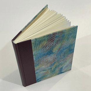 Journal with leather spine and combed paste paper