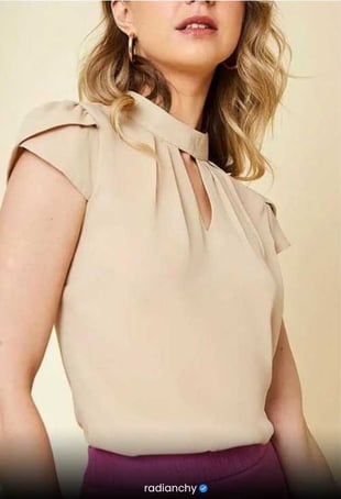 a woman in a beige top with a purple skirt
