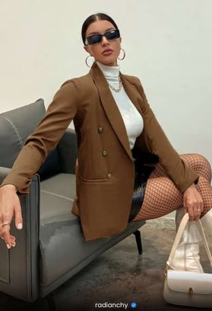 a woman in a brown jacket and stockings