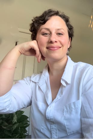 a woman in a white shirt and a black couch