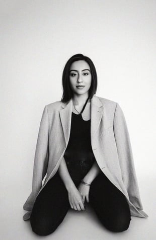 a woman sitting on a chair with her legs crossed