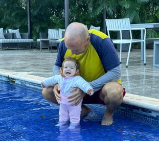 a man and a baby in a pool