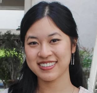 a woman with long black hair and earrings