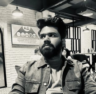 a man with a beard and a beard sitting at a table