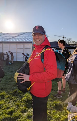 a man in a red jacket and a backpacker