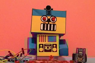 a robot toy with a box of buttons and a toy