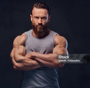 a bearded man with muscles