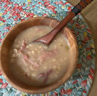 Large Silver Maple bowl with ham and bean soup and a wooden spoon