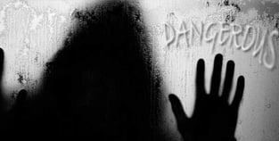 a person's hands are touching the wall of a window