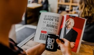 A man reading a guide to success Business