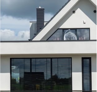 a white house with a large window and a clock on the outside