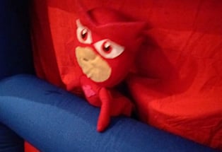 a stuffed animal toy sitting on top of a bouncer
