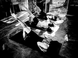 Practioners practice Locust Pose in a yoga class