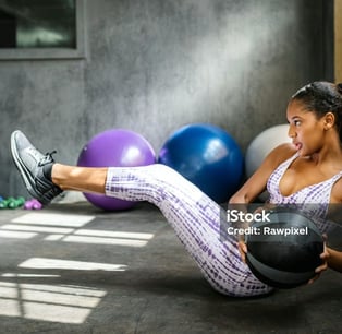a woman doing a crunch ball exercise