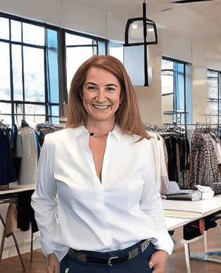 a woman standing in a clothing store